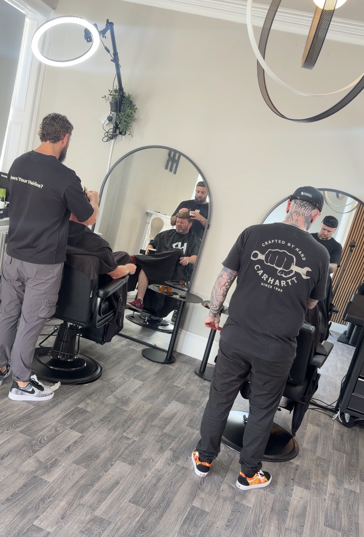 Hair Repair Club specialists working with clients inside the training clinic